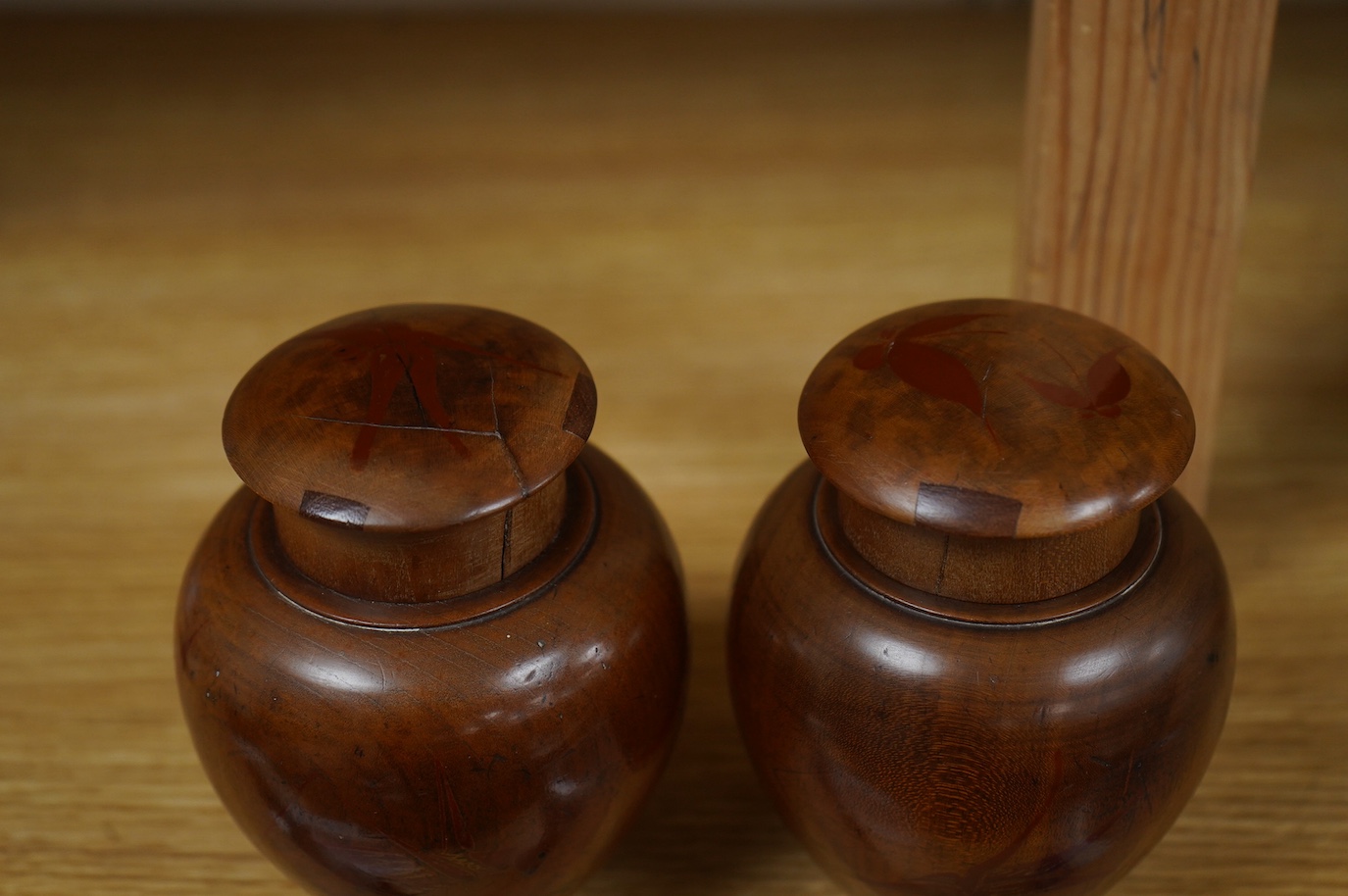 A pair of 18th century lacquered pear wood tea caddies, as seen in Pinto's book, page 293 and plate 315 (D), 12.5cm tall. Condition - repairs to covers, some wear to lacquer